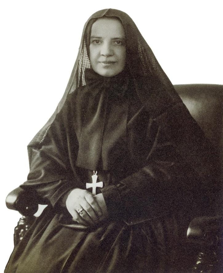 A person in a black robe with a cross

AI-generated content may be incorrect.