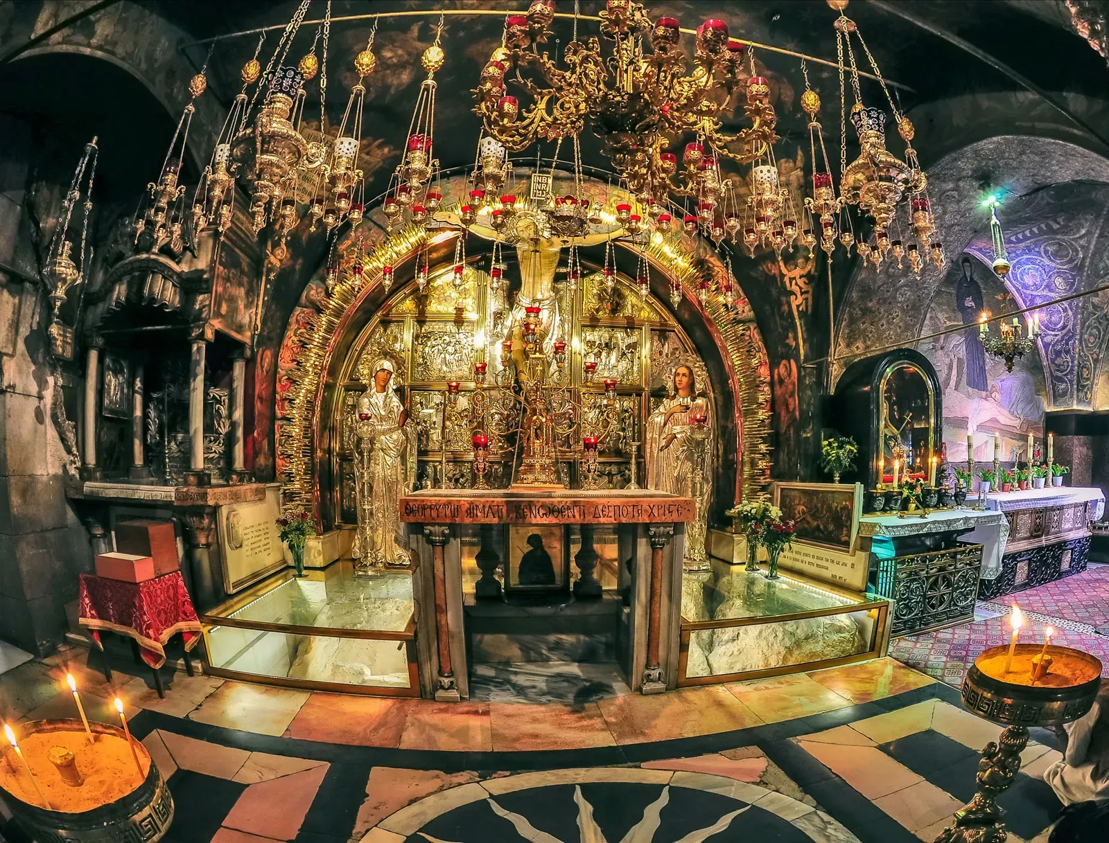 An image of the glittering candle-lit Holy Sepulcher in Jerusalem.