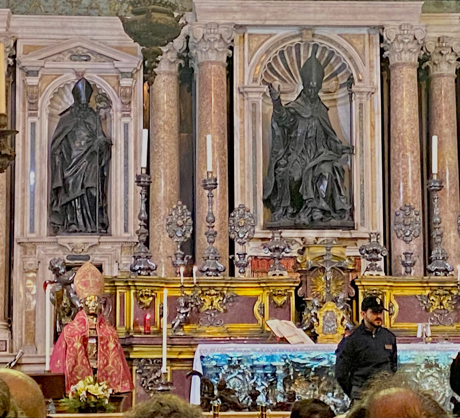 Relics of gold and red (miter and vestment) displayed on silver bust of San Gennaro in Naples, Italy Cathedral. The miter was stolen and recovered. Image Credit: Laura Ruberto.