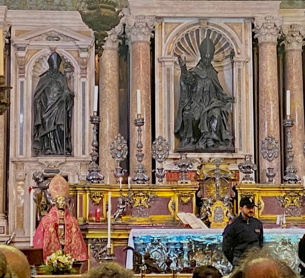 Relics of gold and red (miter and vestment) displayed on silver bust of San Gennaro in Naples, Italy Cathedral. The miter was stolen and recovered. Image Credit: Laura Ruberto.